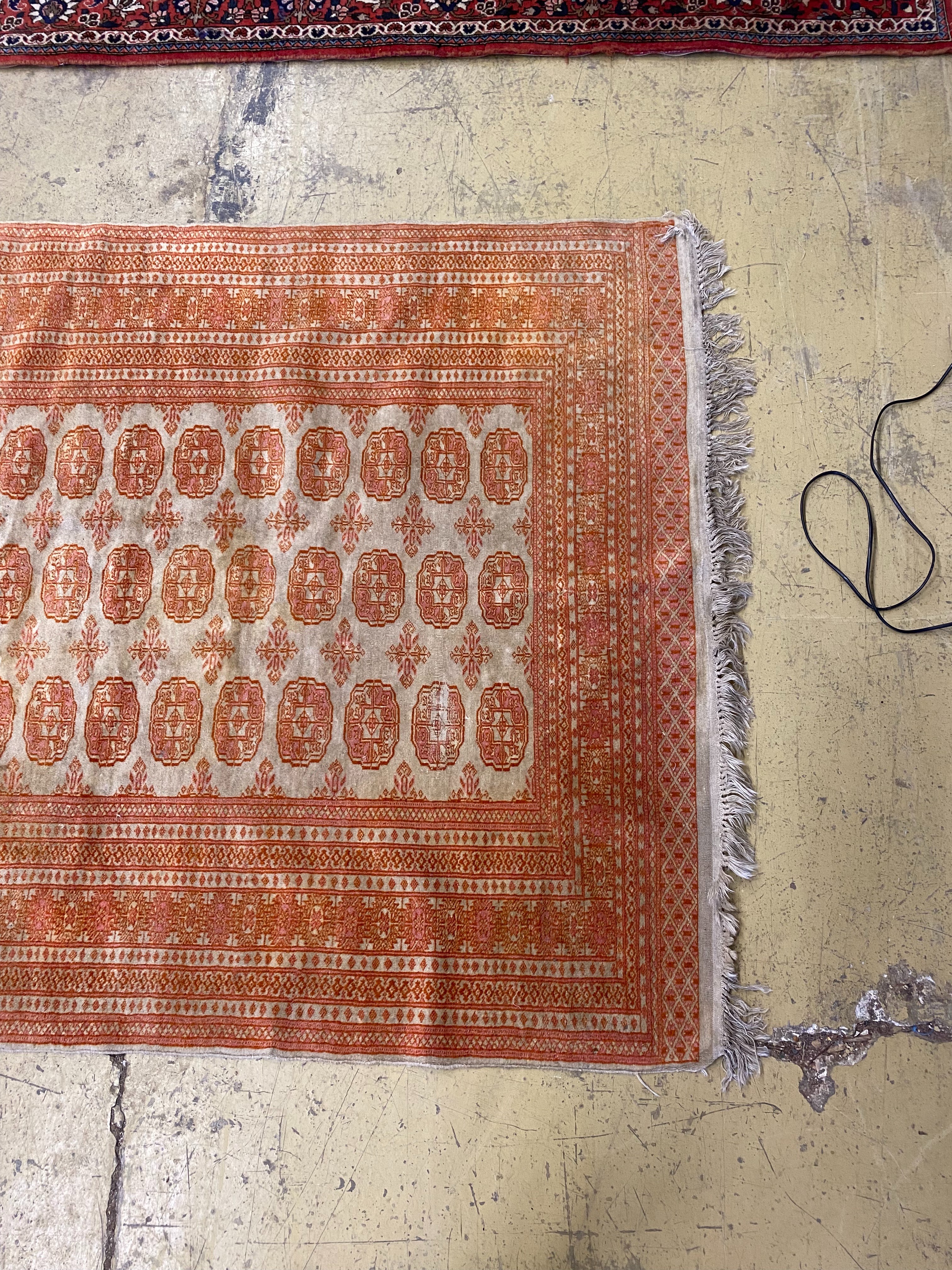 A Bokhara ivory ground rug, 190 x 130cm